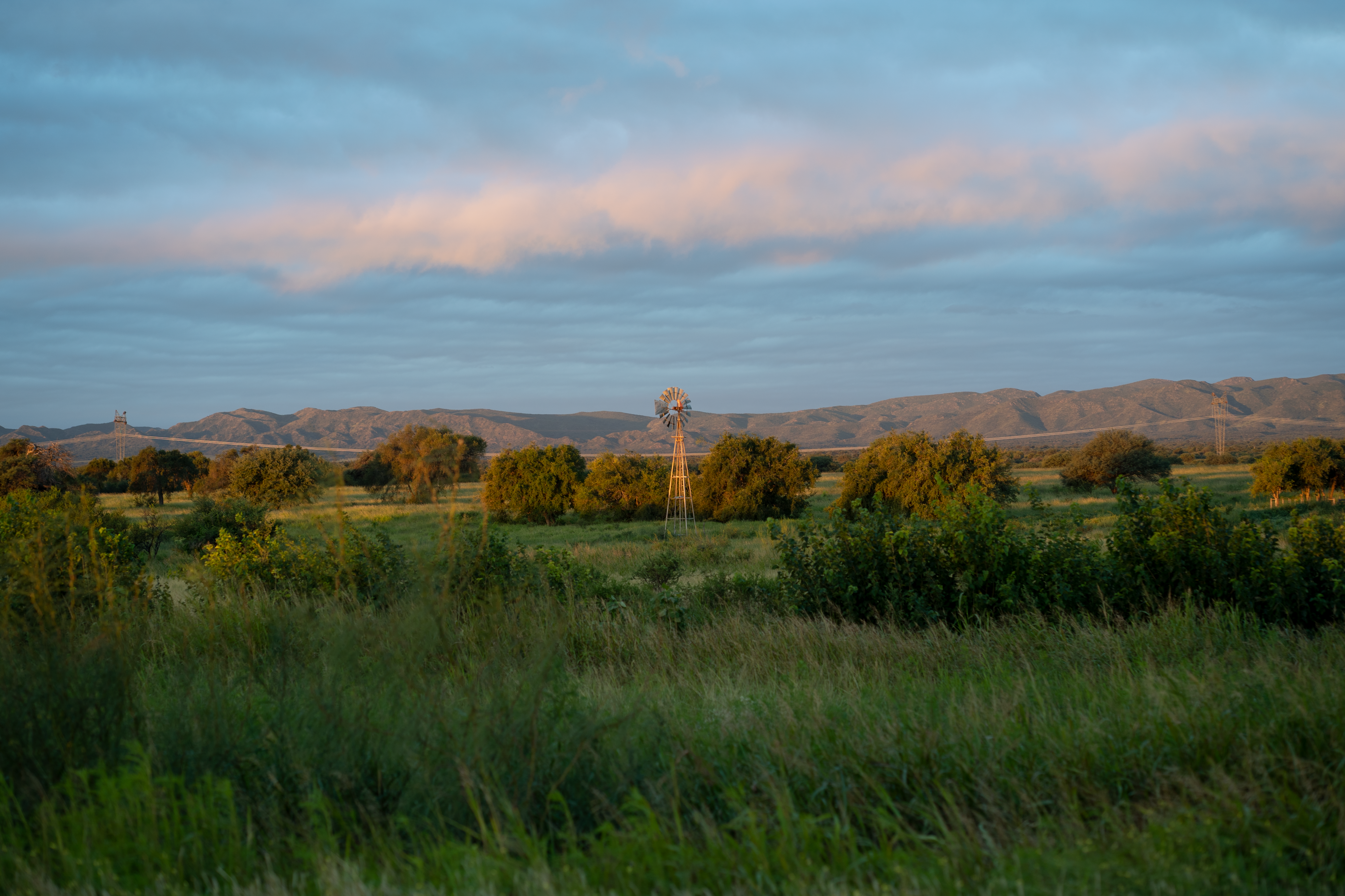 Scenic view of a countryside windmill under a cloudy sky in Córdoba, Argentina.