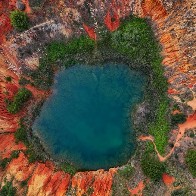 Stunning aerial shot of Cava di Bauxite's vibrant lagoon in Apulia, Italy.