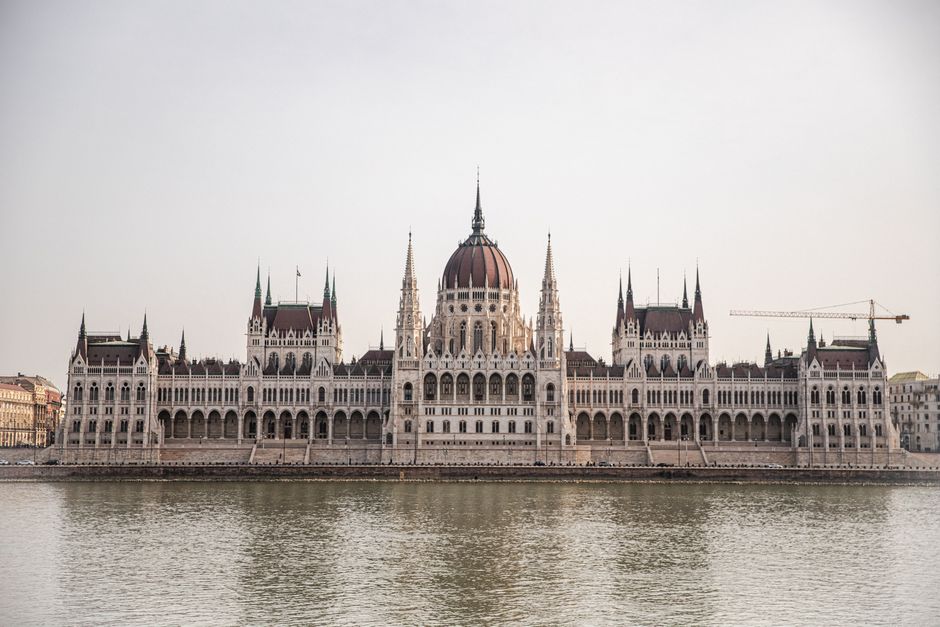 Beautiful capture of the Budapest Parliament Building along the Danube River, showcasing its Gothic Revival architecture.
