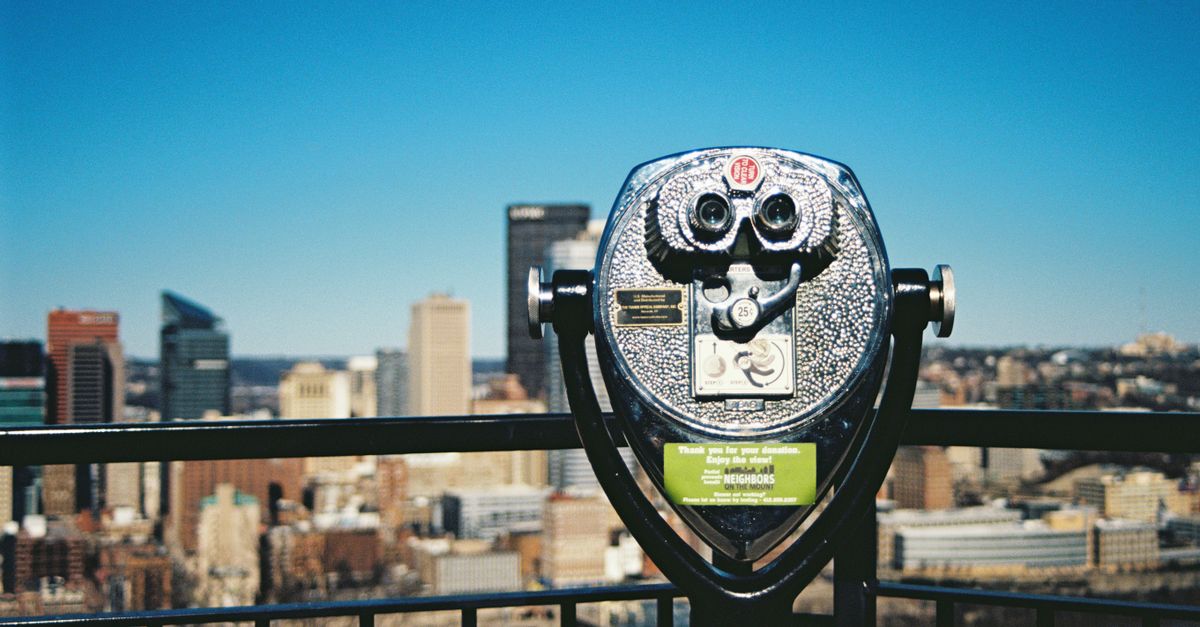 Coin-operated telescope with Pittsburgh skyline in background, stunning urban view.