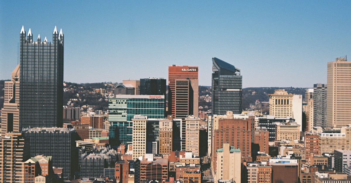 A crisp view of Pittsburgh's skyline with distinct skyscrapers against a clear blue sky.