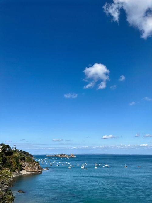 Free Beautiful summer day in Cancale Bay, Brittany with boats on the ocean. Stock Photo