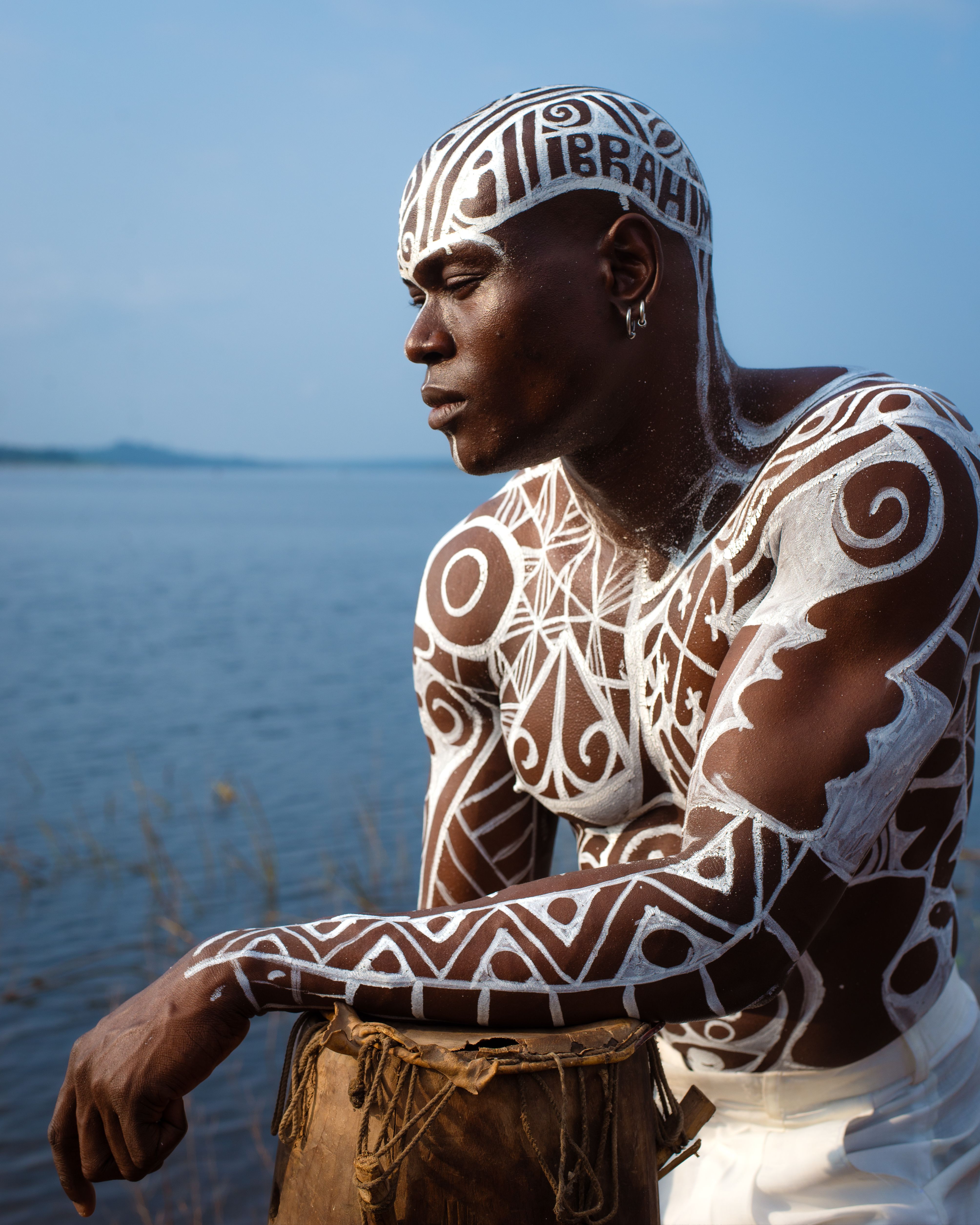 African Man with Traditional Body Art by River · Free Stock Photo