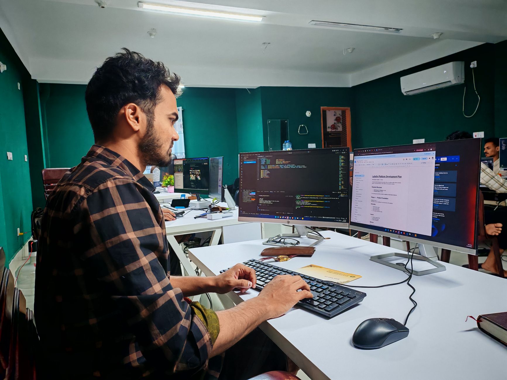 frustrated developer staring at broken code multiple monitors