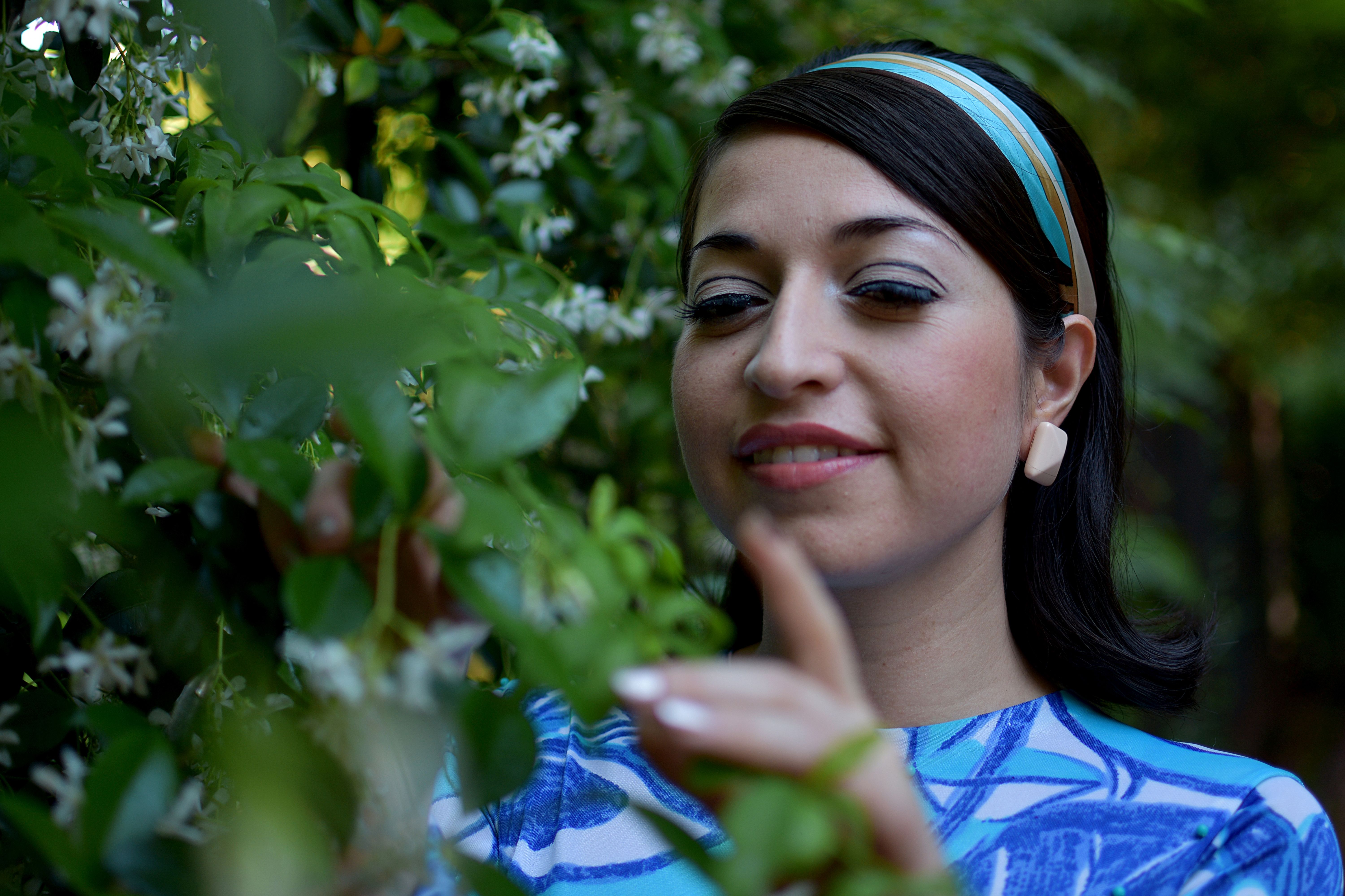 Woman Exploring Nature in a Floral Garden · Free Stock Photo