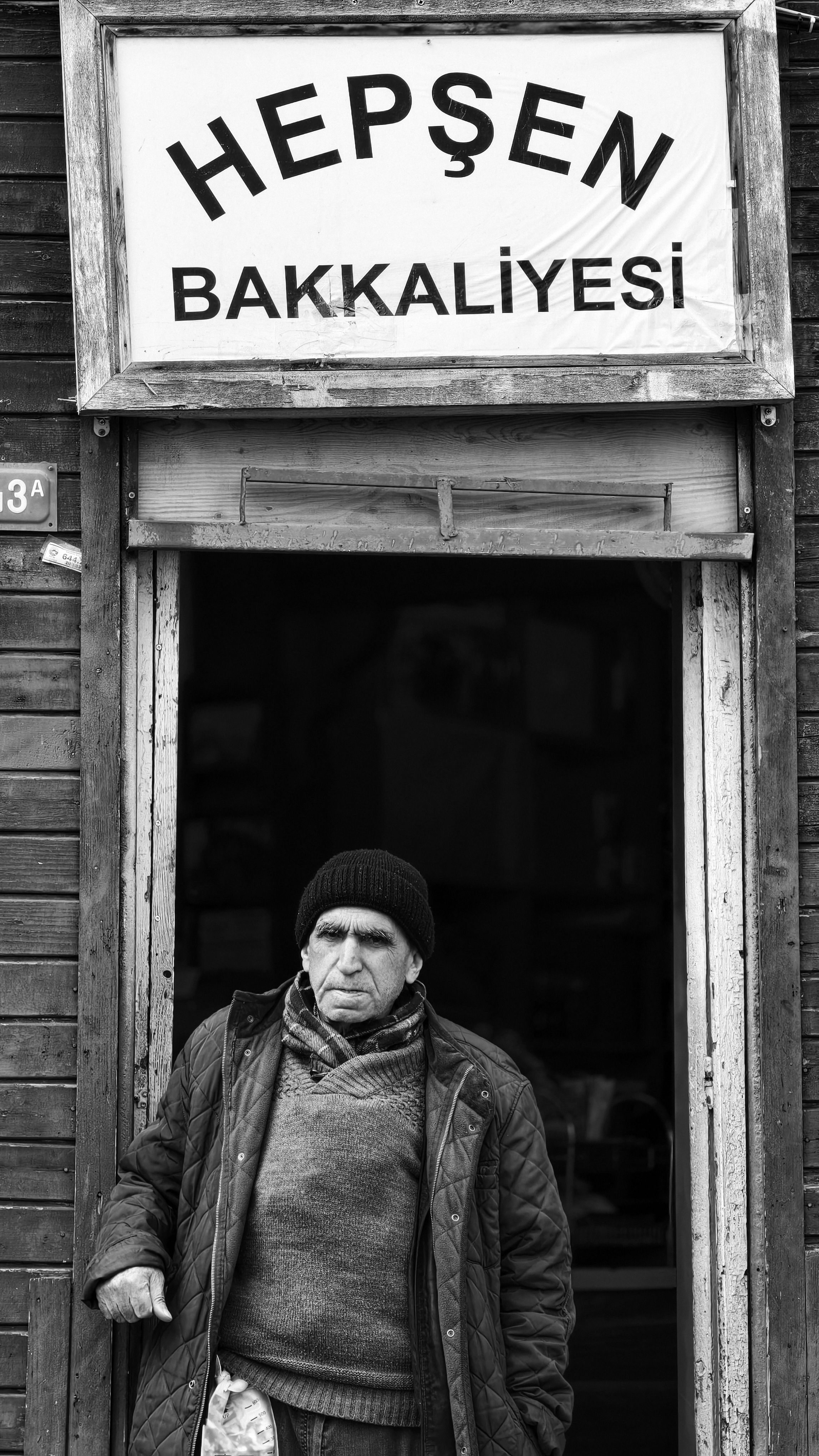 Elderly man standing at the entrance of a traditional Turkish shop in Istanbul.