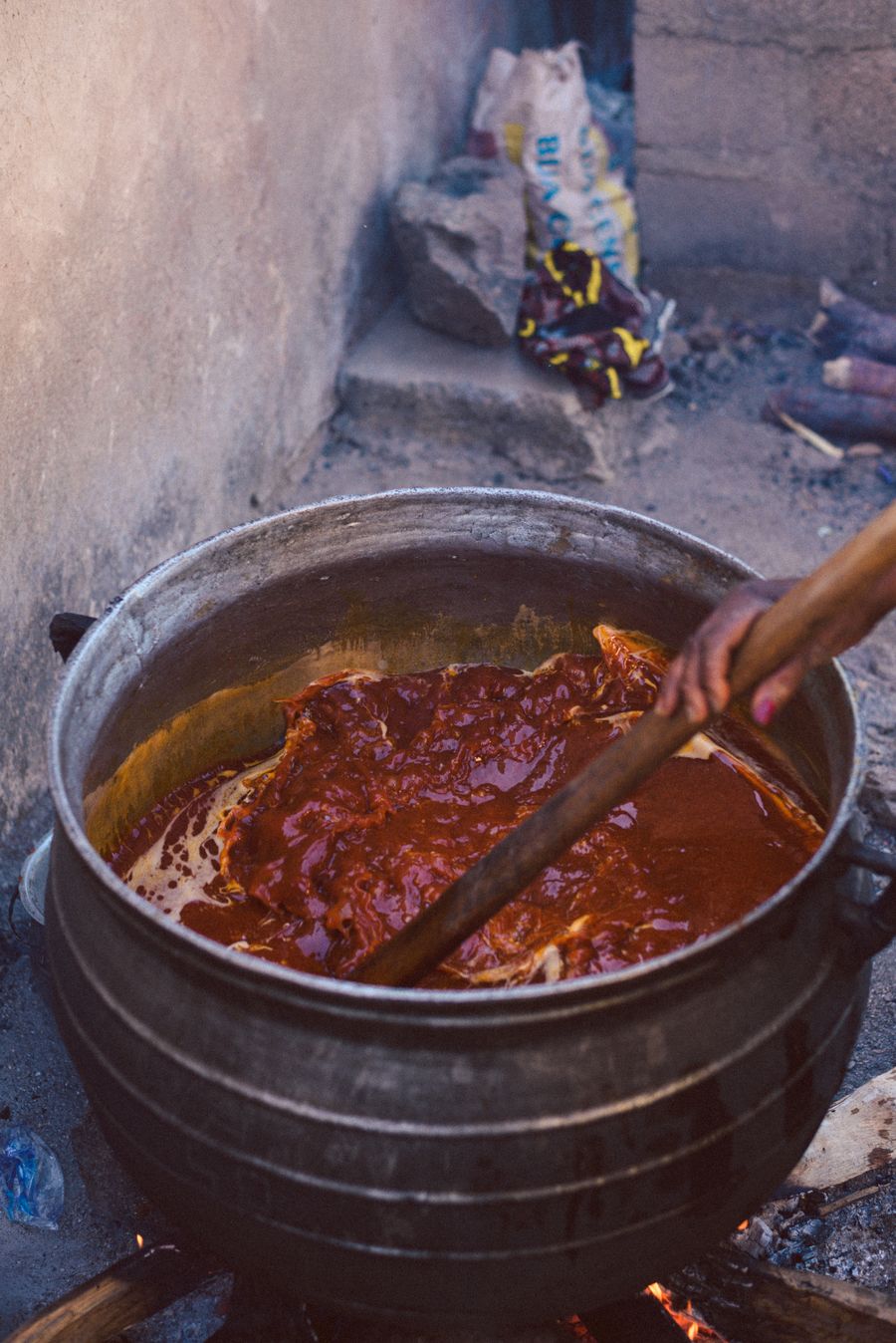 Jollof rice cooking in a large pot