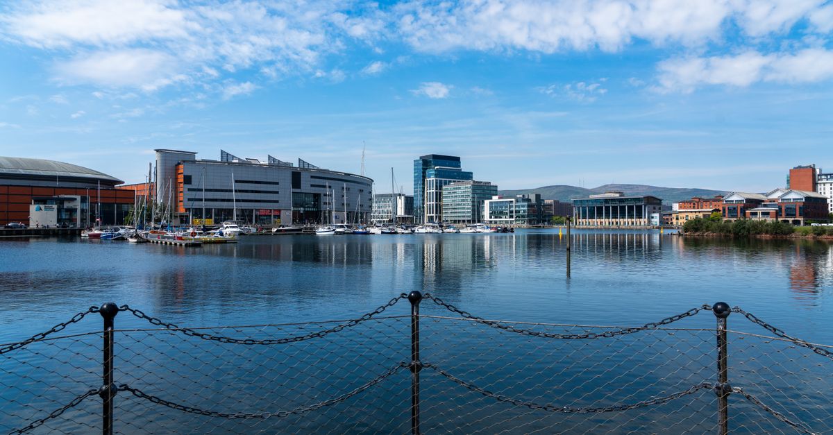 Scenic view of modern architecture and yachts along a waterfront in Ireland.