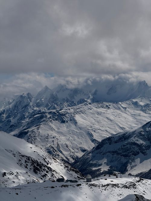 Free Majestic snowy peaks under cloudy skies in Kabardino-Balkaria, Russia. Stock Photo