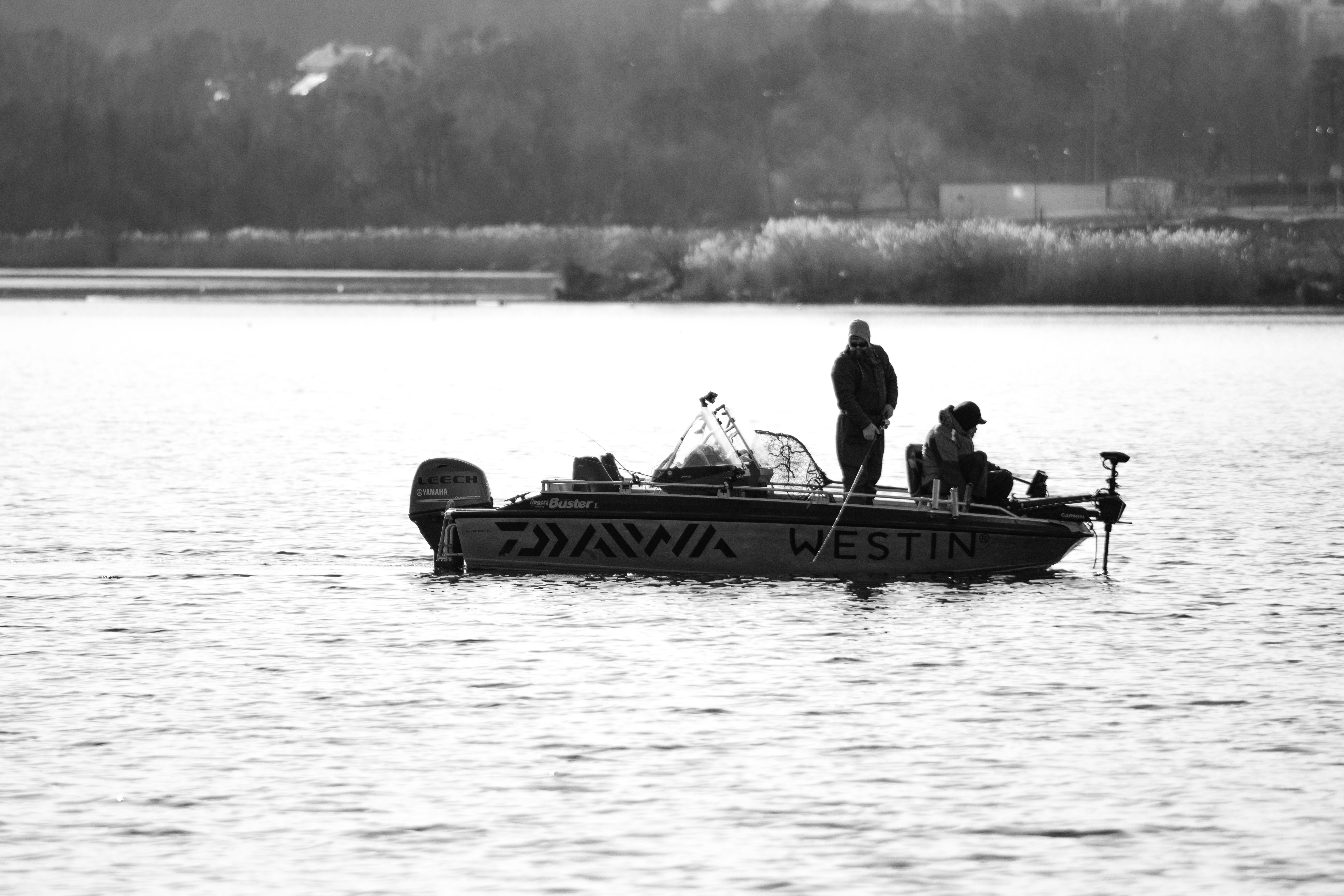 Fishermen on a boat in Jönköping, Sweden, captured in black and white.