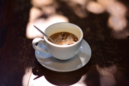 Free Warm cup of coffee with milk in sunlight, creating a cozy atmosphere. Stock Photo