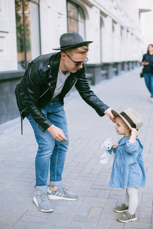 A Man In Black Jacket Staring at Her Daughter