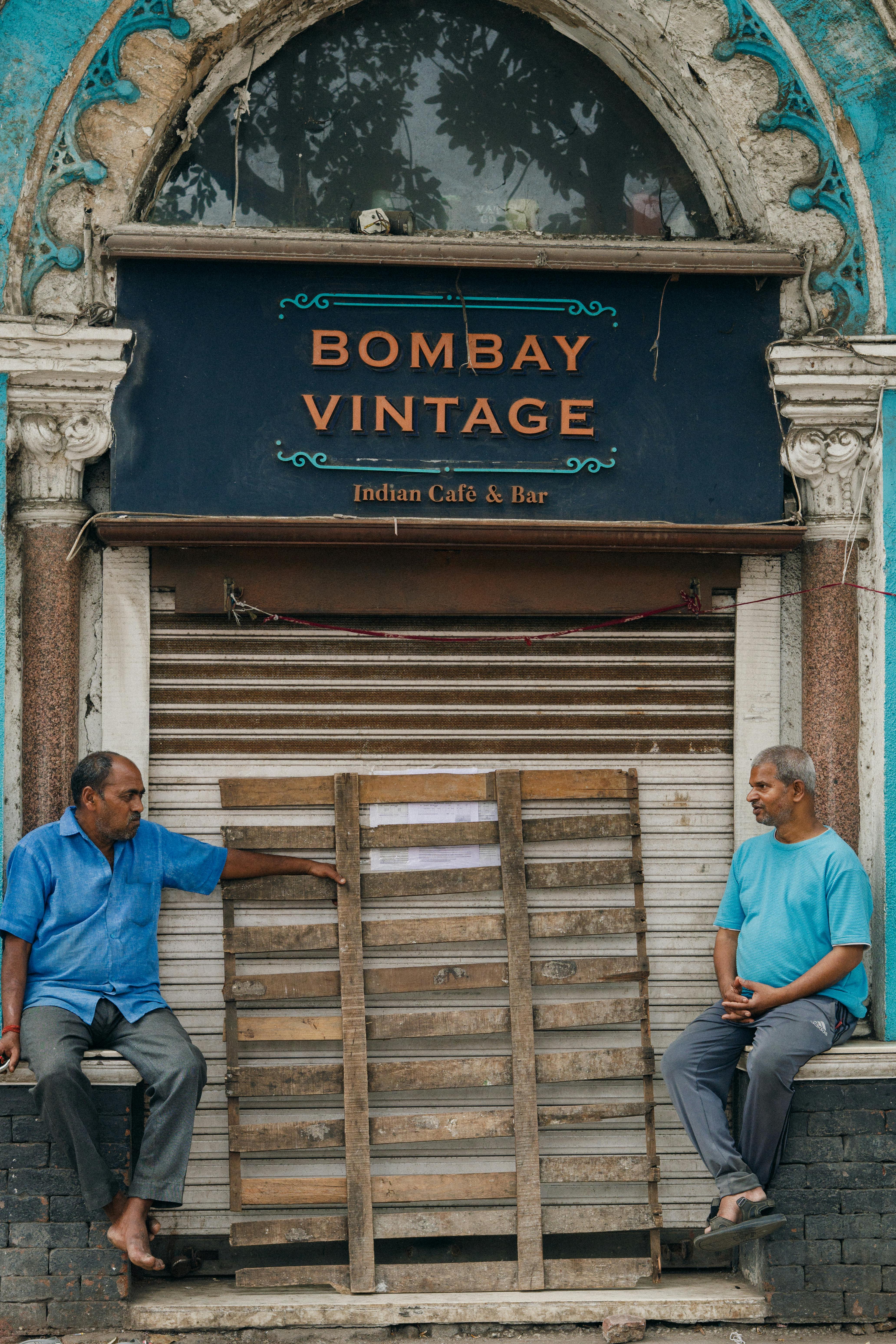 People chatting outside Bombay Vintage Cafe in India