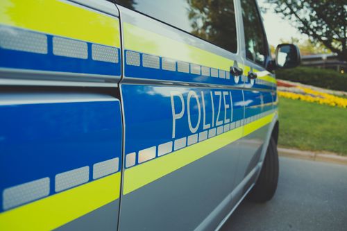 Free Close-up of a German police car labeled 'Polizei' parked outdoors on a sunny day. Stock Photo