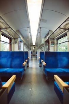 Spacious modern train interior with blue seats, great for public transport concepts.