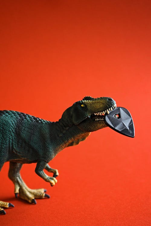 Side View Of Dinosaur On Orange Background