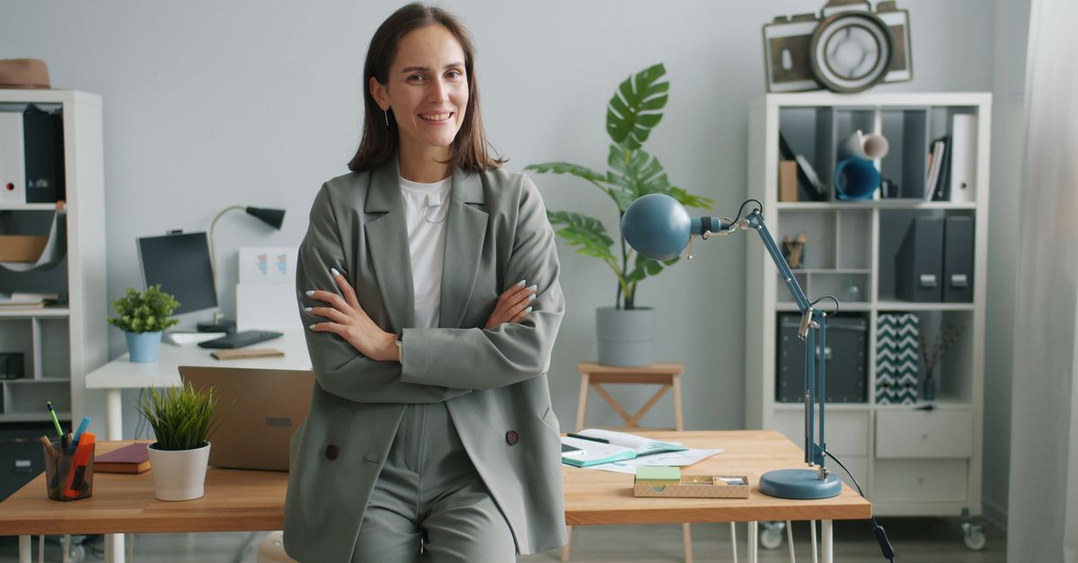 Woman in gray jeans with navy blazer