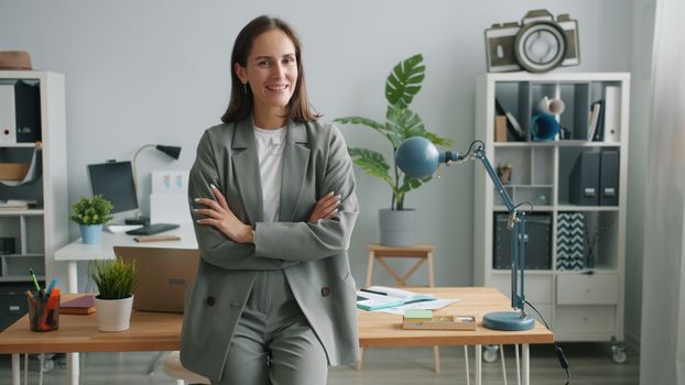 Professional businesswoman smiling confidently in a modern office environment.