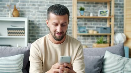 Man on a sofa using a phone