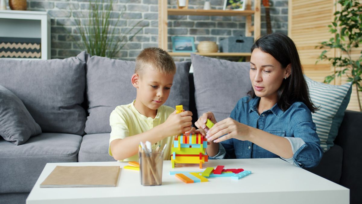 A mother and son building together at home during a weekly LEGO sort and tidy routine