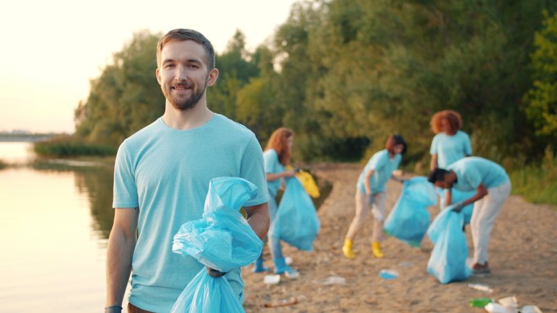 A volunteer on a clean-up day at sunset — photo by Vitaly Gariev on Pexels