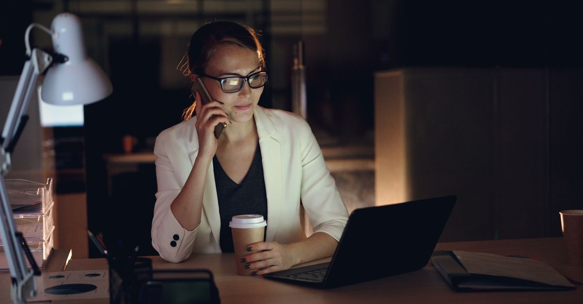 person working late at night with laptop and coffee, creative focus