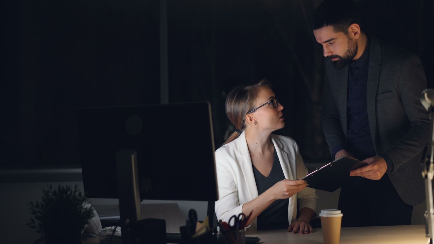 Two TRACTIONCORE specialists reviewing a project together in a dimly lit office