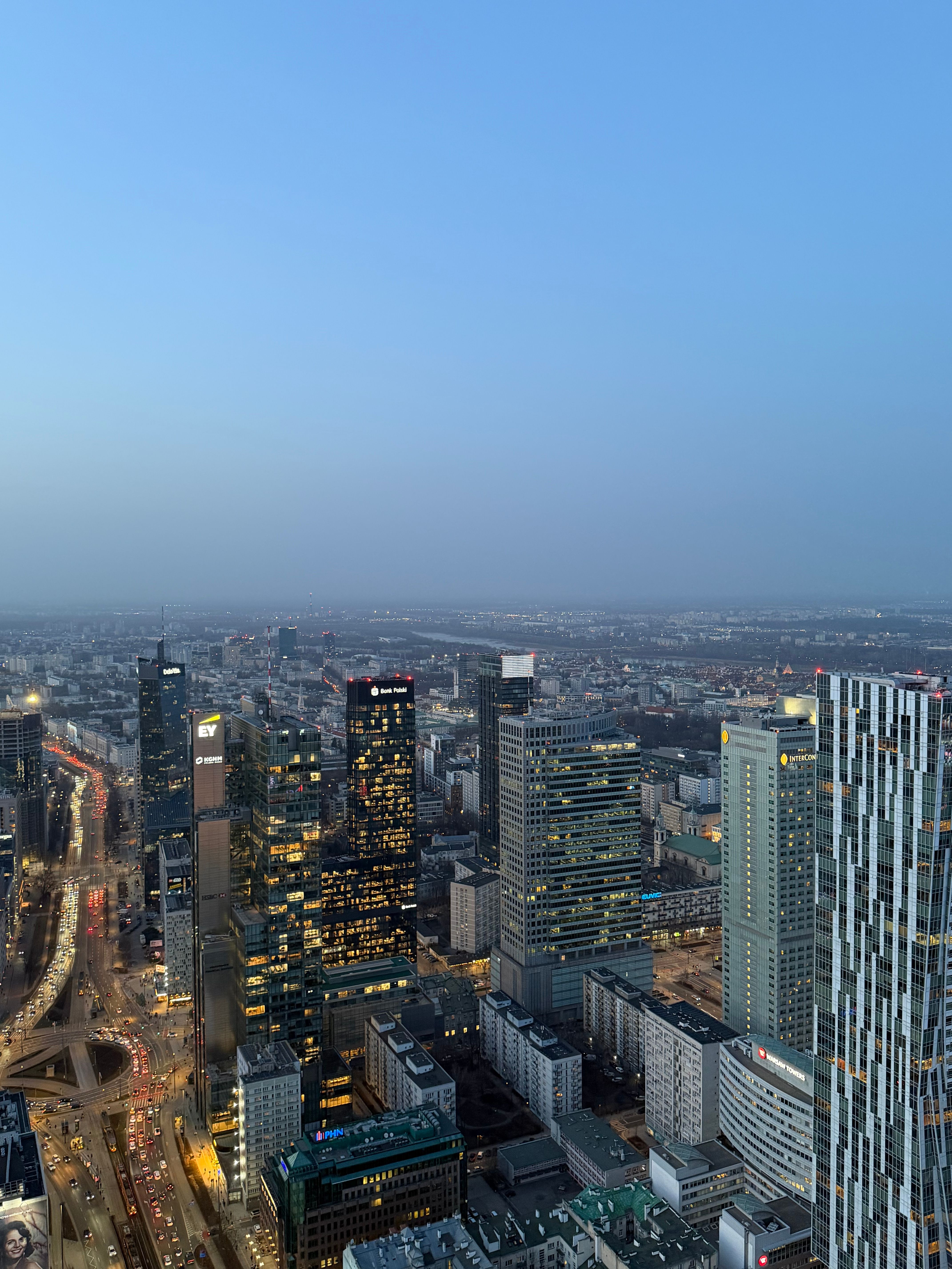 Stunning aerial view of Warsaw's skyline during twilight showcasing modern skyscrapers and city lights.