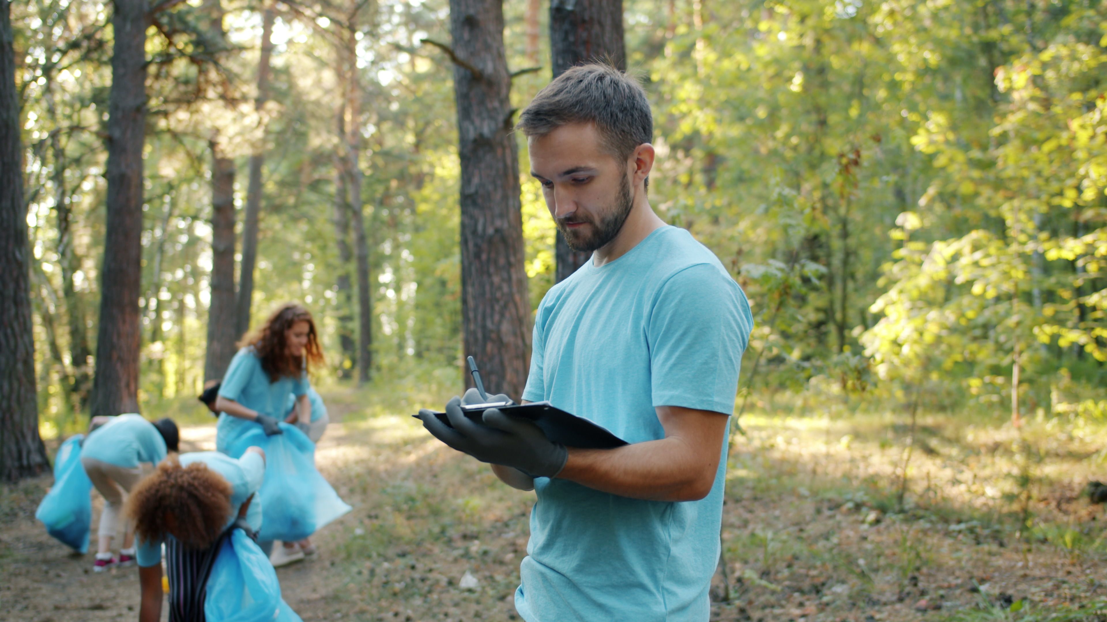 Team Cleaning Up Litter in Forest Setting · Free Stock Photo