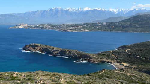 Free Breathtaking aerial view of the picturesque coastline of Calvi, Corsica with mountains in the background. Stock Photo