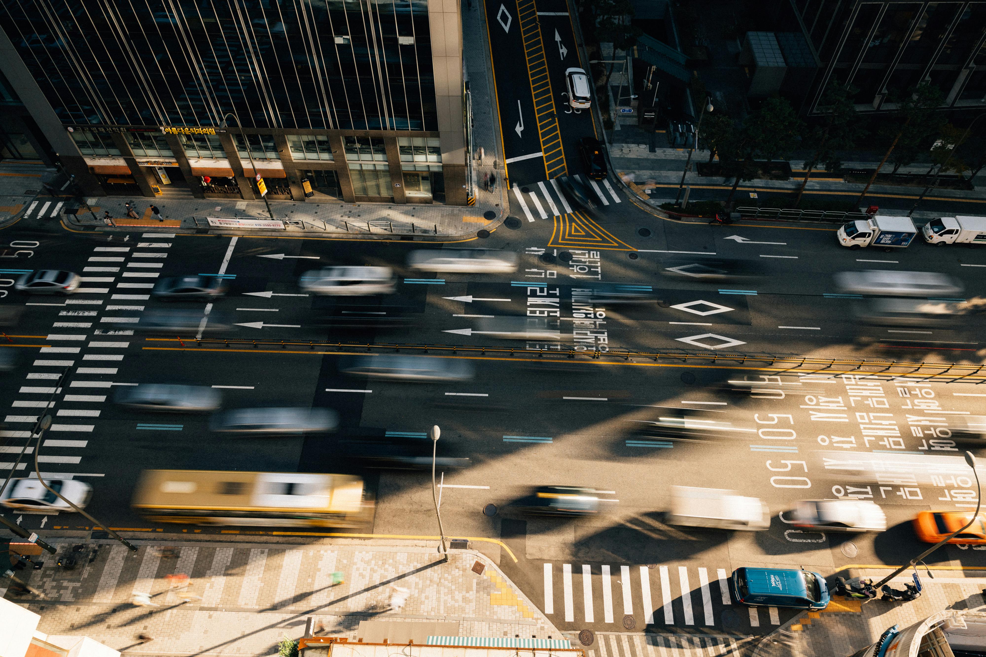 Aerial view of bustling traffic in Seoul with motion blur capturing urban energy.