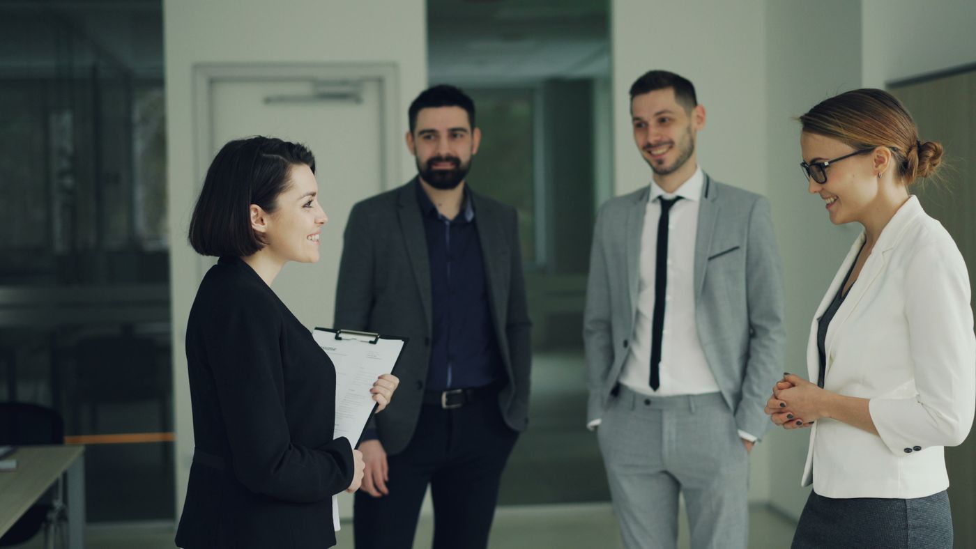 A small leadership team holding a strategy meeting in a modern office