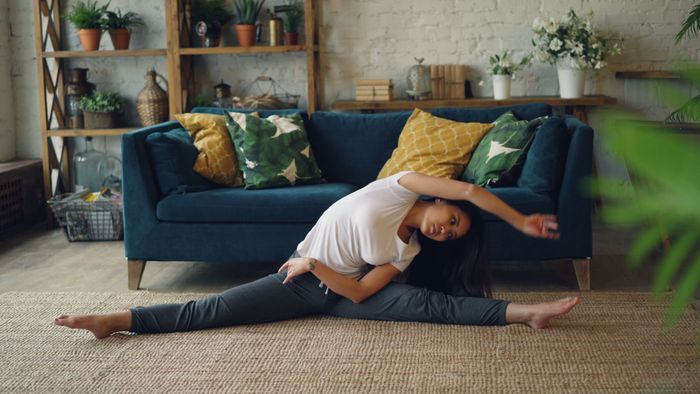 Side stretch on an indoor floor — Vitaly Gariev on Pexels