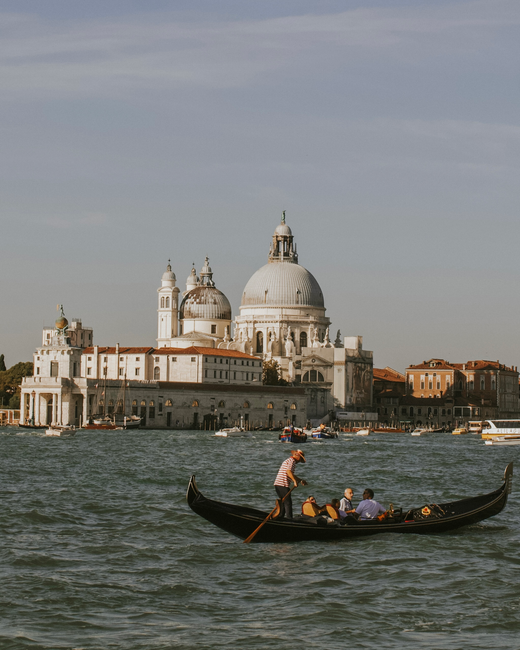 Scenic view of a gondola on Venice's Grand Canal with Santa Maria della Salute in the background.