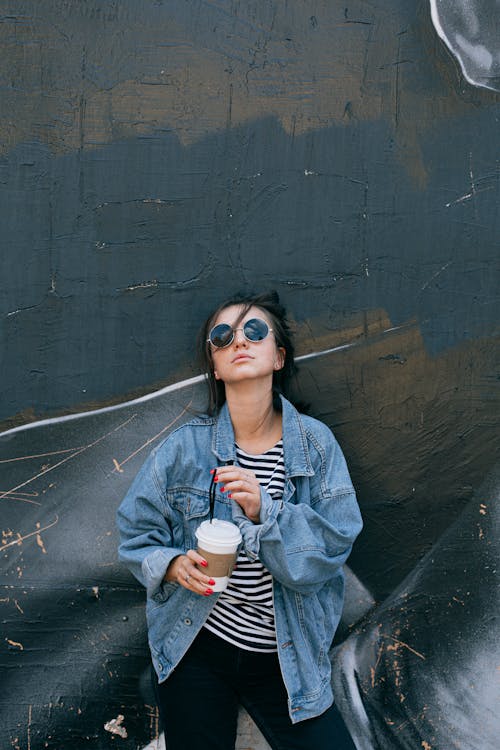 Free Woman in Blue Denim Jacket Holding White Cup Stock Photo