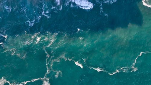 Free Stunning aerial view of the turquoise sea waves in Cantabria, Spain. Stock Photo