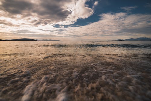무료 일몰시 해 안에 충돌하는 바다 파도 스톡 사진