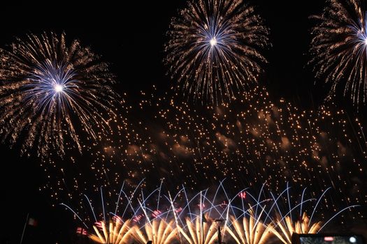 Spectacular fireworks light up the night sky with vibrant colors and patterns, celebrating a festive occasion.