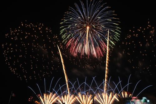 Free A stunning fireworks display bursting with vibrant colors across the night sky, capturing the essence of celebration. Stock Photo