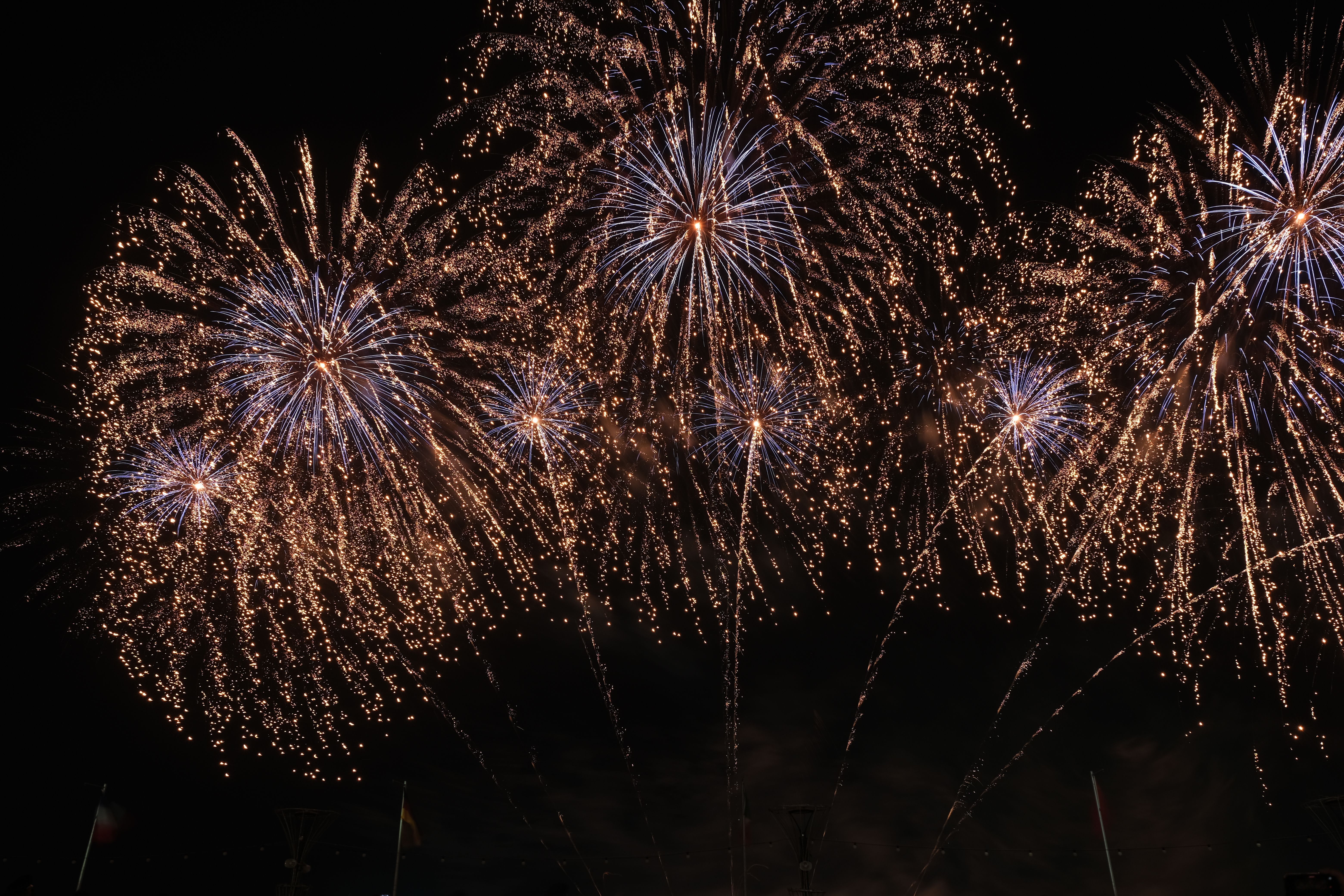 Dazzling fireworks display lighting up the night sky with colorful explosions representing the celebratory and often comedic atmosphere of major tournament opening ceremonies