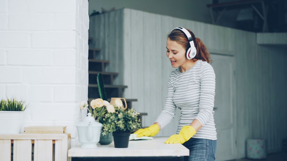 A Bizzy Bees cleaner tidying a bright living room