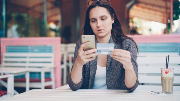 A person reviewing their monthly budget and BNPL payment plans on a smartphone.