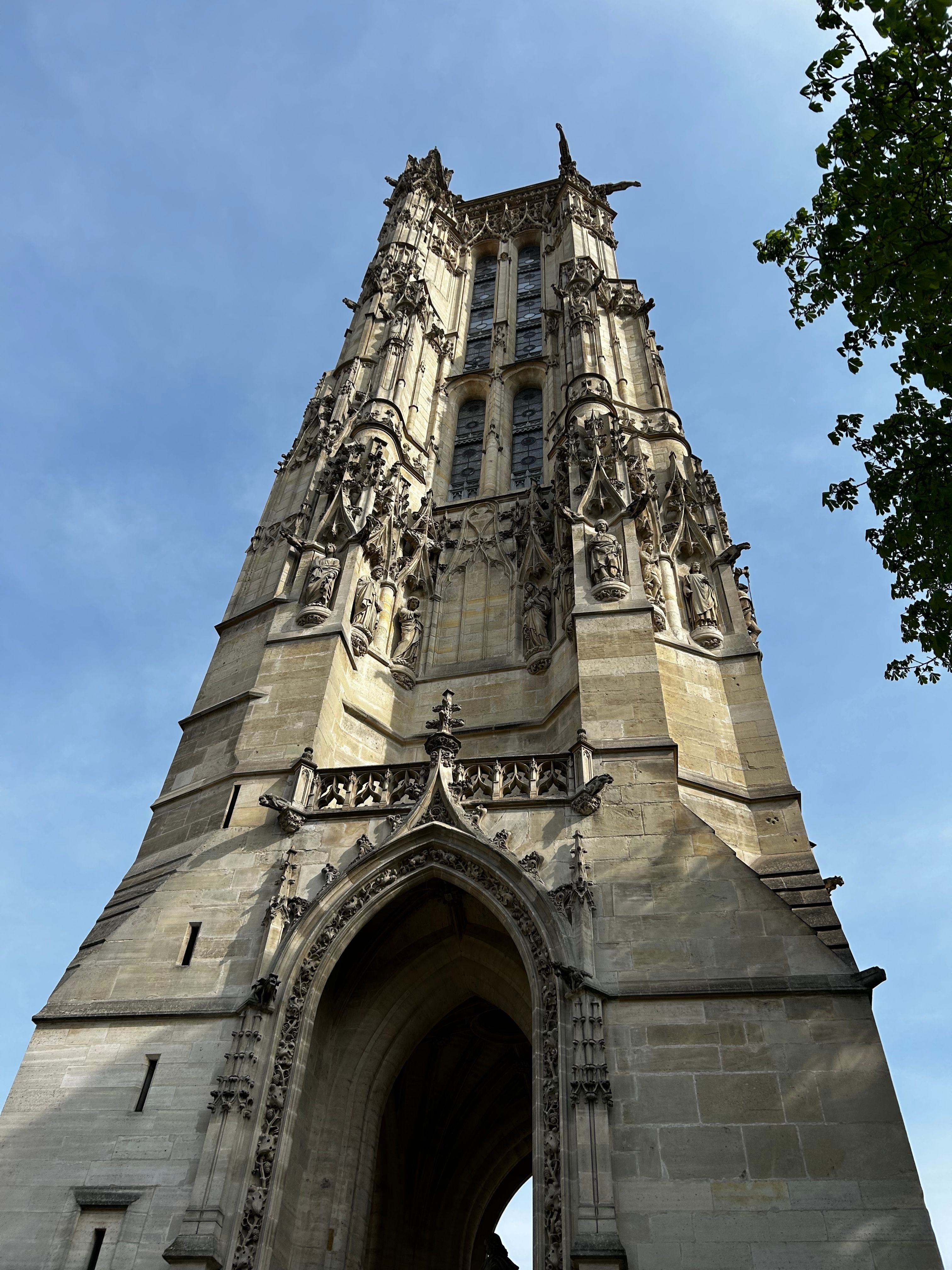 Majestic view of the historic St. Jacques Tower in Paris under a clear blue sky.