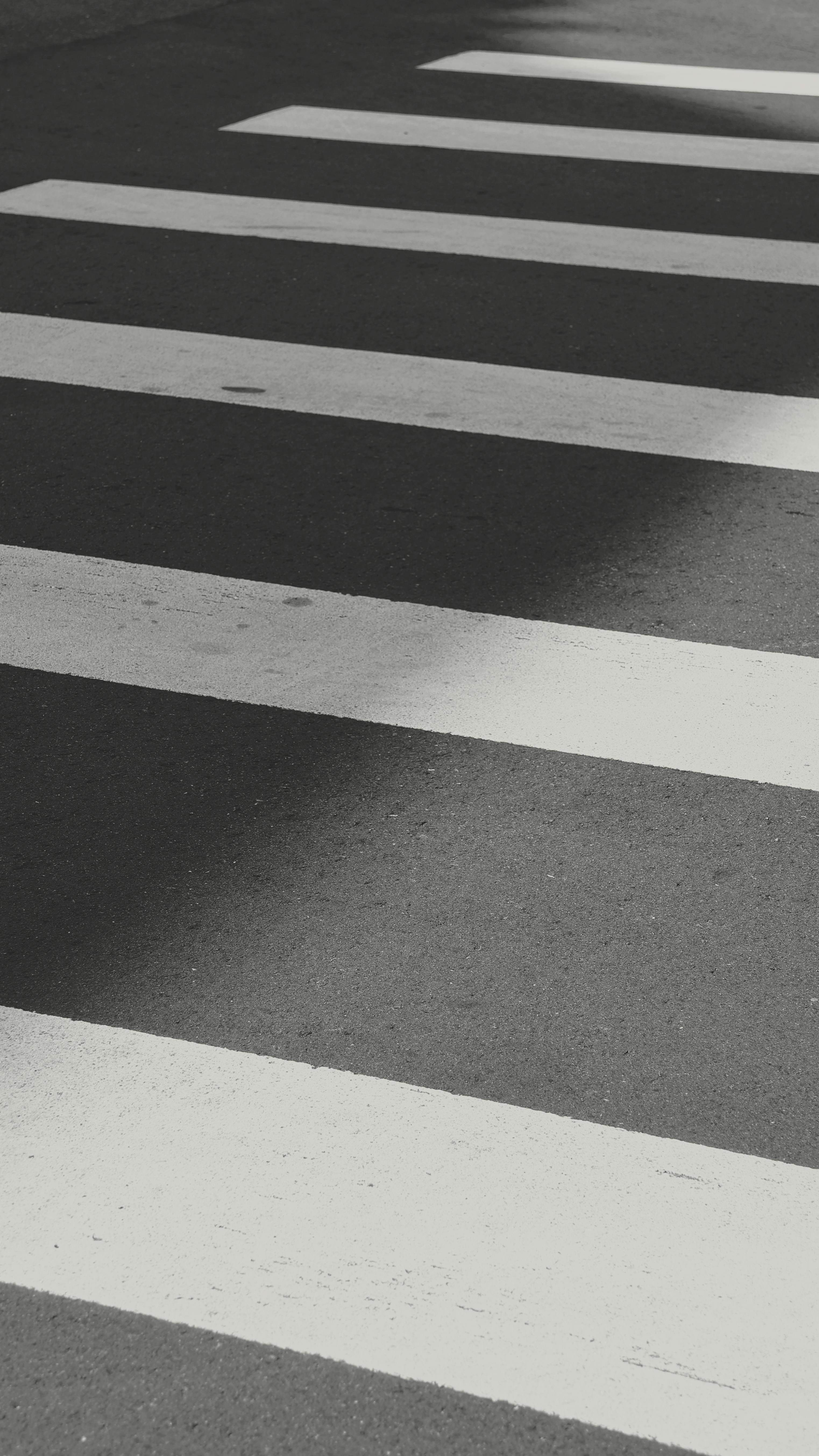 Black and white photo of a zebra crosswalk with shadow play, taken in Taiwan.