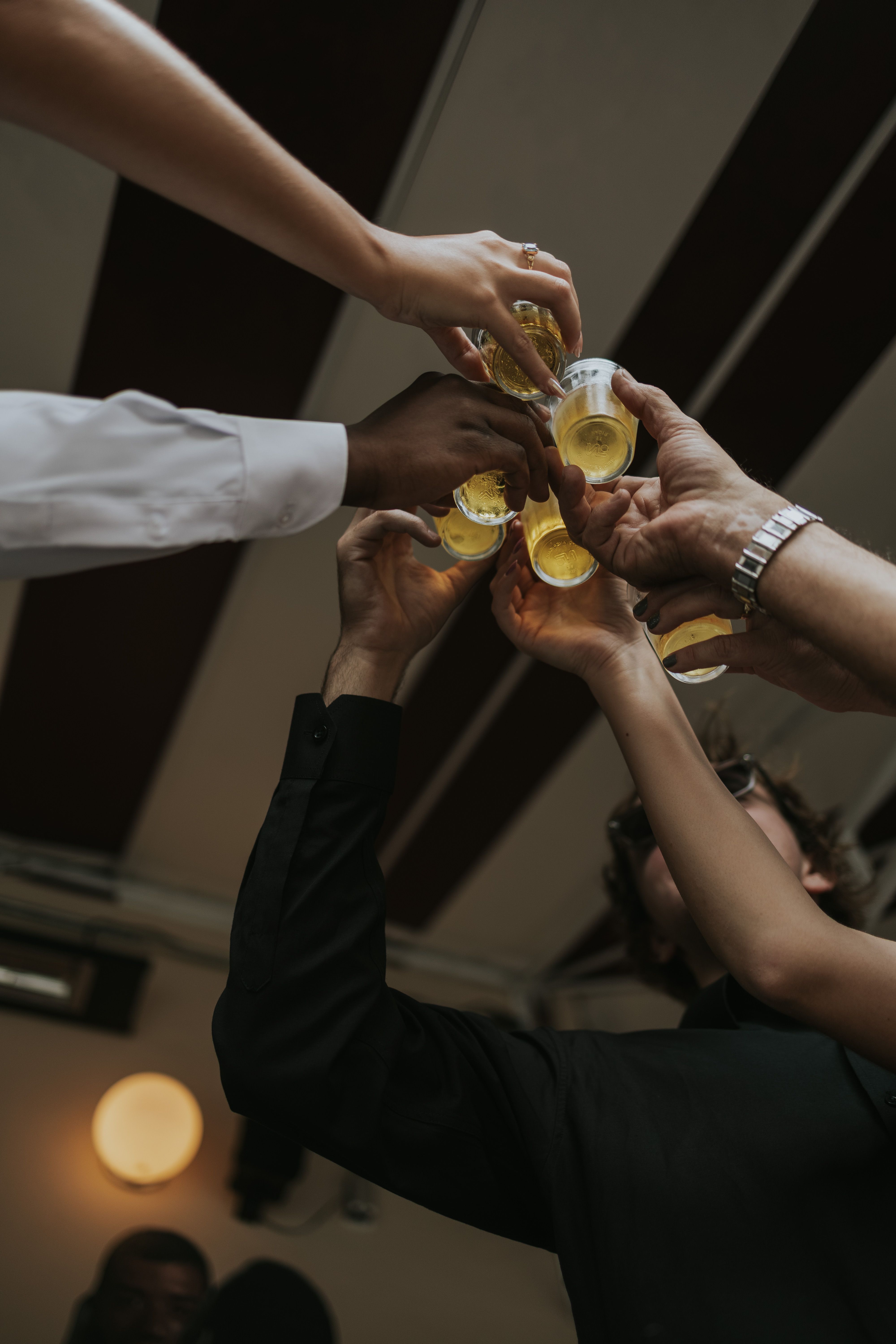 Friends raise glasses for a toast, celebrating a joyful occasion. Cheers!