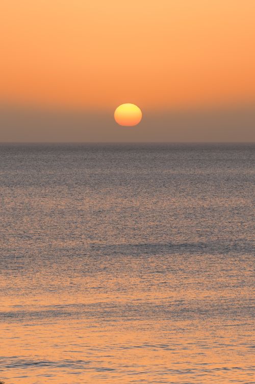 Free Peaceful sunrise over the Atlantic Ocean capturing warm hues at Kanarische Inseln, Spain. Stock Photo