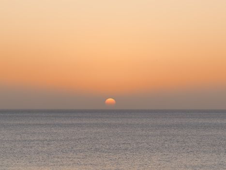Beautiful sunrise on a calm sea horizon from the Canary Islands, Spain.