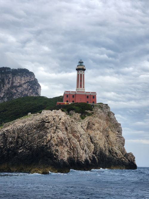 Free Dramatic view of Punta Carena Lighthouse on rocky cliffs of Capri, Italy. Stock Photo