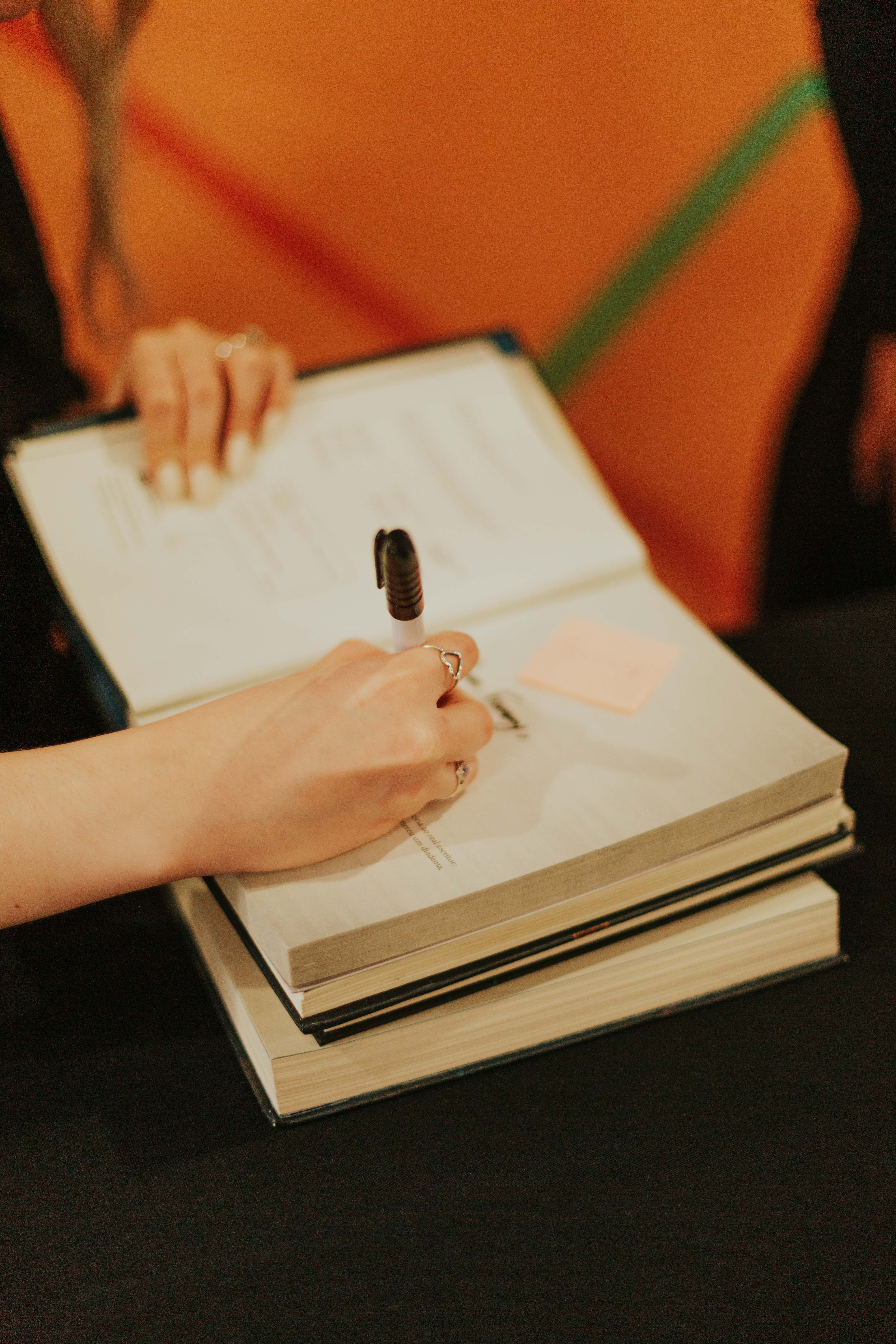 Author Signing a Book at Literary Event · Free Stock Photo