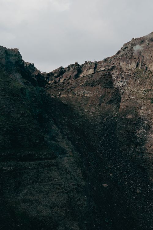Free A dramatic view of Mount Vesuvius' crater, capturing its rugged volcanic landscape. Stock Photo